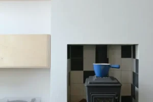 Fireplace in a pleasant living room with a modern record player nearby on a low table.